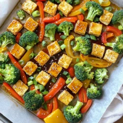 - 1 Block (400 g) fester Tofu, gepresst und gewürfelt - 250 g Brokkoliröschen - 250 g Paprika (verschiedene Farben), in Streifen geschnitten - 250 g Karotten, dünn aufgeschnitten - 3 Esslöffel Teriyaki-Sauce - 2 Esslöffel Sojasauce - 1 Esslöffel Olivenöl - 2 Knoblauchzehen, fein gehackt - 1 Teelöffel frischer Ingwer, gerieben - 1 Esslöffel Sesamsamen - 3 Frühlingszwiebeln, in Ringe geschnitten (zum Garnieren) - Salz und Pfeffer nach Geschmack Für dieses Rezept brauchst du frischen Tofu. Festen Tofu ist am besten, da er gut die Marinade aufnimmt. Das Gemüse macht das Gericht bunt und nahrhaft. Brokkoli, Paprika und Karotten passen wunderbar zusammen. Die Marinade ist der Schlüssel. Du mischst Teriyaki-Sauce und Sojasauce mit Olivenöl. Knoblauch und Ingwer geben Extra-Geschmack. Sesamsamen sorgen für einen knusprigen Biss. Frühlingszwiebeln sind ein toller Farbklecks oben drauf. Mit diesen Zutaten zauberst du ein einfaches, gesundes Gericht. Bereite alles vor und lass uns kochen! Heize deinen Ofen auf 220 °C vor. Das ist wichtig für eine schöne Bräunung. Lege ein großes Backblech mit Backpapier aus. Das macht das Putzen einfacher. Bereite die Marinade vor. Mische in einer Schüssel die Teriyaki-Sauce, Sojasauce, Olivenöl, gehackten Knoblauch und geriebenen Ingwer. Diese Mischung gibt dem Tofu viel Geschmack. Lege die gewürfelten Tofu-Stücke in die Marinade. Wende sie vorsichtig. Lass den Tofu mindestens 10 Minuten ziehen. So kann er die Aromen aufnehmen. Wasche das Gemüse gut. Schneide den Brokkoli, die Paprika und die Karotten. Sie sollten alle gleich groß sein, damit sie gleichmäßig garen. Gib alles in eine separate Schüssel. Träufle etwas Olivenöl darüber und würze mit Salz und Pfeffer. Mische alles gut durch. Das Gemüse sollte gleichmäßig bedeckt sein. Verteile den marinierten Tofu und das Gemüse gleichmäßig auf dem Backblech. Achte darauf, dass sie sich nicht überlappen. Backe das Ganze für 25-30 Minuten. Rühre einmal während des Backens um. So wird der Tofu goldbraun und das Gemüse zart. Sobald es fertig ist, nimm das Blech aus dem Ofen. Streue die Sesamsamen gleichmäßig darüber. Jetzt ist dein Gericht bereit zum Servieren! - Aromen anpassen: Sie können die Marinade nach Ihrem Geschmack ändern. Fügen Sie mehr Ingwer oder Knoblauch hinzu für mehr Geschmack. Wenn Sie es süßer mögen, versuchen Sie einen Hauch von Honig oder Ahornsirup. - Alternativen zur Teriyaki-Sauce: Wenn Sie keine Teriyaki-Sauce haben, nutzen Sie Sojasauce. Mischen Sie sie mit Honig und etwas Reisessig. Das gibt einen ähnlichen süßen und salzigen Effekt. - Tipps für knusprigen Tofu: Um knusprigen Tofu zu bekommen, pressen Sie den Tofu gut. Lassen Sie ihn nach dem Schneiden 10 Minuten auf einem Papiertuch ruhen. Das nimmt überschüssige Feuchtigkeit auf. - Gemüsearten auswählen: Wählen Sie Gemüse, das gut im Ofen gart. Brokkoli, Paprika und Karotten passen perfekt. Auch Zucchini oder Süßkartoffeln sind tolle Optionen. - Serviervorschläge: Servieren Sie das Gericht auf einer großen Platte. Garnieren Sie es mit geschnittenen Frühlingszwiebeln und Sesam. Das sieht toll aus und macht Lust auf mehr. - Beilagenideen: Dazu passt gedämpfter Reis oder Quinoa. Sie können auch einen frischen Salat servieren, um das Gericht aufzulockern. {{image_4}} Für eine vegane Variante können Sie den Tofu durch Seitan ersetzen. Seitan hat eine ähnliche Textur und nimmt die Marinade gut auf. Anstelle von Teriyaki-Sauce können Sie auch Miso-Paste verwenden. Miso verleiht einen tiefen, umami-Geschmack. Sojasauce bleibt eine tolle Option, wenn Sie das Gericht würzen. Saisonales Gemüse bringt frische Aromen ins Gericht. Probieren Sie Zucchini, Kürbis oder grüne Bohnen. Diese Gemüsearten passen gut zu Tofu und Teriyaki-Sauce. Eine bunte Mischung aus Gemüse sieht nicht nur gut aus, sie schmeckt auch toll. Kombinieren Sie Brokkoli mit roter Paprika oder Karotten mit Zucchini. Wenn Sie mehr Protein möchten, fügen Sie Kichererbsen oder Edamame hinzu. Diese Hülsenfrüchte sind nahrhaft und einfach zuzubereiten. Sie können sie einfach mit dem Gemüse mischen. Auch Tempeh ist eine großartige Wahl. Tempeh hat einen einzigartigen Geschmack und ergänzt die Marinade perfekt. Um die Reste deines Sheet-Pan Teriyaki Tofu und Gemüse gut zu lagern, stelle sicher, dass du sie in einem luftdichten Behälter aufbewahrst. So bleiben die Aromen frisch. Im Kühlschrank halten sich die Reste etwa 3 bis 4 Tage. Achte darauf, sie so schnell wie möglich zu kühlen, um die Frische zu bewahren. Wenn es Zeit ist, die Reste aufzuwärmen, gibt es einige beste Methoden. Du kannst die Mischung in einer Pfanne bei mittlerer Hitze erwärmen. Dies sorgt dafür, dass der Tofu knusprig bleibt. Alternativ kannst du die Reste auch in der Mikrowelle aufwärmen. Stelle die Mikrowelle auf mittlere Leistung und erwärme es in 30-Sekunden-Intervallen. Rühre zwischendurch um, um eine gleichmäßige Erwärmung zu erzielen. Das Einfrieren von Tofu und Gemüse ist einfach, aber es gibt ein paar Tipps zu beachten. Schneide den Tofu in Stücke und lege ihn in einen gefriersicheren Behälter. Du kannst das Gemüse auch in Portionsgrößen einfrieren. So hast du immer eine schnelle Mahlzeit bereit. Achte darauf, die Luft aus dem Behälter zu drücken, bevor du ihn schließt, um Gefrierbrand zu vermeiden. Tofu kann bis zu 3 Monate eingefroren werden, Gemüse bleibt frisch für etwa 6 Monate. Ja, du kannst dieses Rezept im Voraus zubereiten. Marinierter Tofu hält sich gut im Kühlschrank. Du kannst den Tofu und das Gemüse am Vorabend vorbereiten. Lege sie einfach in die Marinade und bewahre sie abgedeckt im Kühlschrank auf. So ziehen die Aromen besser ein. Am nächsten Tag musst du nur noch das Gemüse und den Tofu auf das Backblech legen und backen. Es spart Zeit und macht das Kochen einfacher. Um matschigen Tofu zu vermeiden, drücke das Wasser gut aus. Nutze ein sauberes Küchentuch oder einen Tofu-Press. Das hilft, die Textur zu verbessern. Wähle festen Tofu, denn er gibt dem Gericht mehr Biss. Marinier den Tofu nicht zu lange. Zehn Minuten reichen, um den Geschmack aufzunehmen, ohne die Struktur zu beeinträchtigen. Backe ihn bei hoher Temperatur, damit er schön knusprig wird. Ja, du kannst glutenfreie Optionen wählen. Verwende glutenfreie Sojasauce oder Tamari anstelle der normalen Sojasauce. Achte bei der Teriyaki-Sauce auf die Zutatenliste. Einige Marken sind glutenfrei, andere nicht. Frisches Gemüse und Tofu sind von Natur aus glutenfrei. Mit diesen Anpassungen bleibt das Gericht lecker und glutenfrei. Dieses Rezept zeigt, wie man ein leckeres Gericht mit Tofu und frischem Gemüse zubereitet. Wir haben die Zutaten aufgelistet, eine einfache Anleitung gegeben und nützliche Tipps geteilt. Du kannst auch Variationen ausprobieren und Reste clever lagern. Denke daran, die Marinade nach deinem Geschmack anzupassen und frisches Gemüse zu wählen. Mit diesen Tricks zauberst du schnell ein gesundes Essen. Probiere es aus und entdecke deinen eigenen Stil!